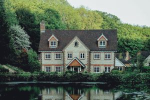 Grande maison devant de l'eau, avec nature en fond